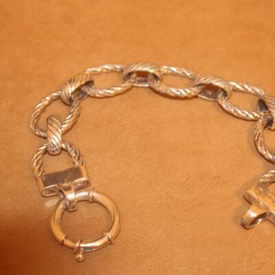 Sterling silver open curve link bracelet.