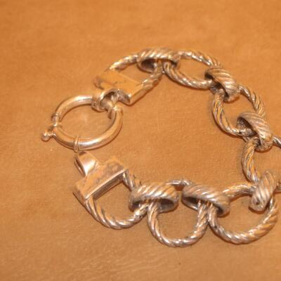 Sterling silver open curve link bracelet.