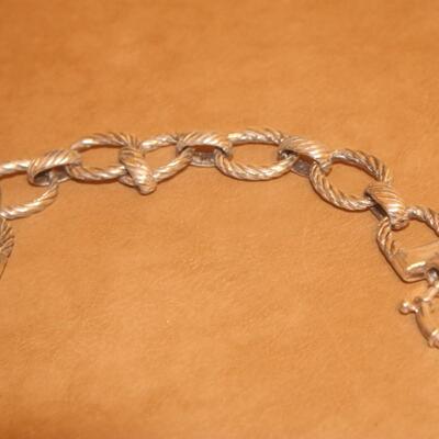 Sterling silver open curve link bracelet.