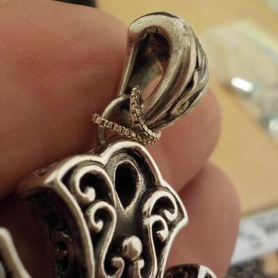 Sterling silver cross euro design with black onyx stone.