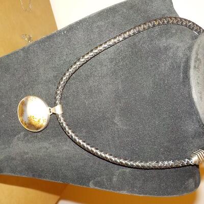 Sterling silver Celtic design with leather wrap chain.