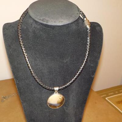 Sterling silver Celtic design with leather wrap chain.