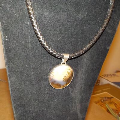 Sterling silver Celtic design with leather wrap chain.