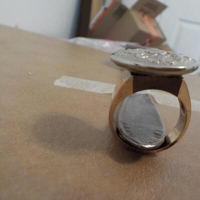 10 K gold base and sterling silver design top ring.
