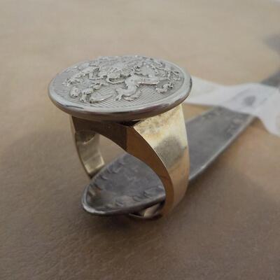 10 K gold base and sterling silver design top ring.