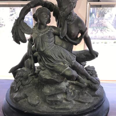 Antique statue of Man and woman bronze - love on the rocks