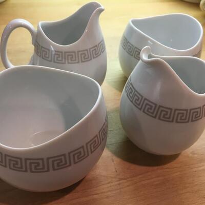 Pair of sugar bowls and pitchers
