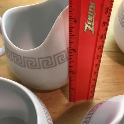 Pair of sugar bowls and pitchers