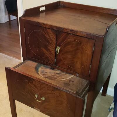Antique chamber pot concealed as side table