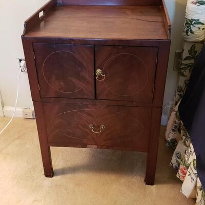 Antique chamber pot concealed as side table