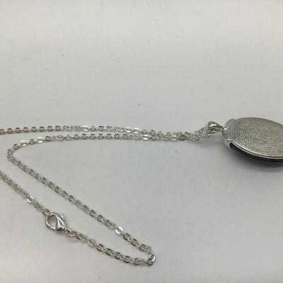 Silver tone necklace with purple stone pendant