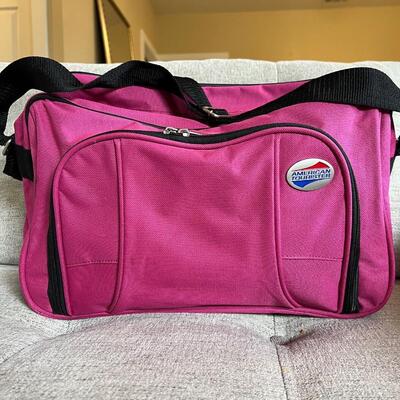 American Tourister pink carry on bag