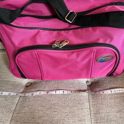 American Tourister pink carry on bag