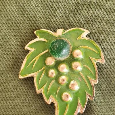 Vintage green hat or cap with pins