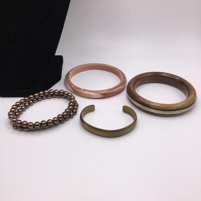 LOTJ158: Four Costume Bracelets - Metal, Wood, Plastic