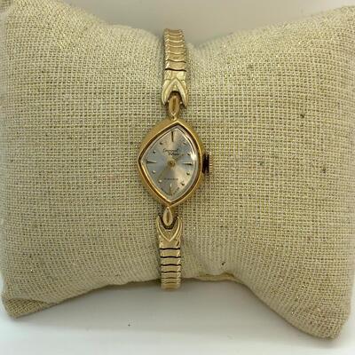 LOT:13: Antique Germinal Voltaire 17 Jewel Lady’S Gold-tone stretch band Wristwatch