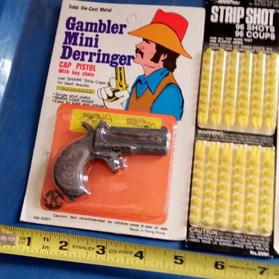 LOT 126 TWO CAP GUN KEY CHAINS WITH CAPS | EstateSales.org