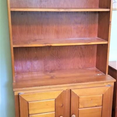 Lot #113  Knotty Pine Bookcase with Storage Below