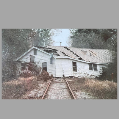 Framed Photograph of a House Moved by Katrina to the Railroad Tracks