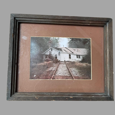 Framed Photograph of a House Moved by Katrina to the Railroad Tracks