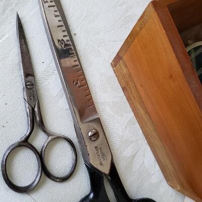 Antique sewing box with buttons, scissors and wooden spools
