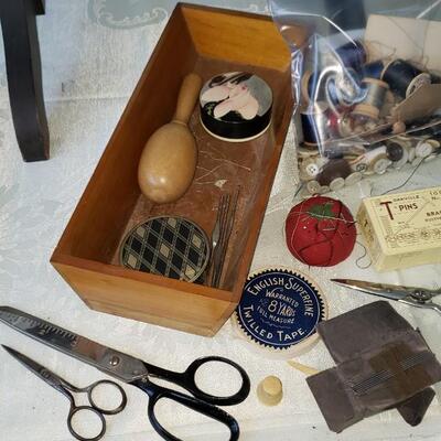 Antique sewing box with buttons, scissors and wooden spools