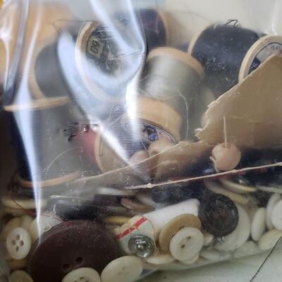 Antique sewing box with buttons, scissors and wooden spools