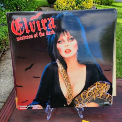 Lot 201: Vintage Elvira Cut-Out, Calendars, Prints, VHS. And More