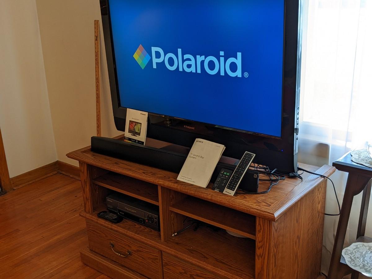 Quality Polaroid TV, Sony Sound Bar, and Entertainment Center