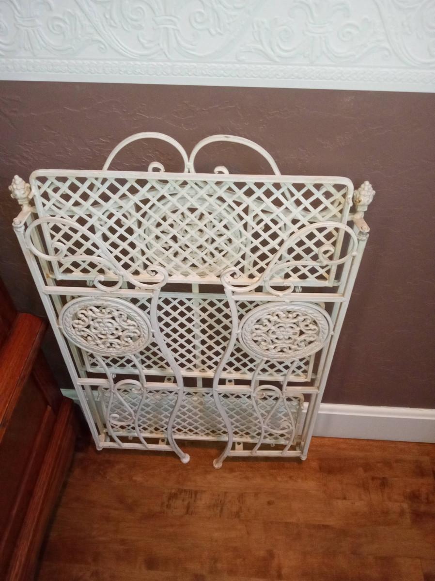 LOT 84 IRON FOLDING SHELF WITH PICTURE FRAMES | EstateSales.org