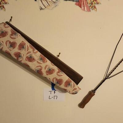 Iron board and old fashioned carpet dusters