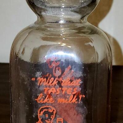 Milk jugs and carrier.