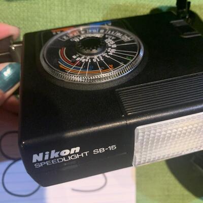 Nikon camera, extra zoom lens, and speed light flash