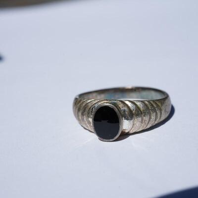 SIZE 7 1/2 LADIES RING. STAMPED 925 FOR STERLING WITH ONYX STONE