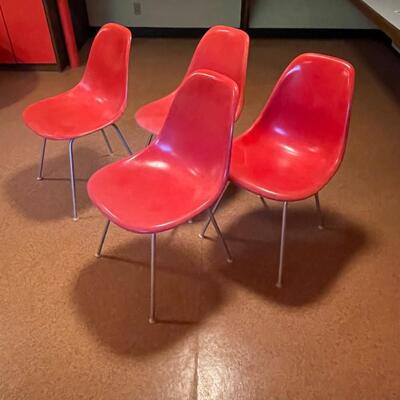 4 red Herman Miller molded plastic chairs