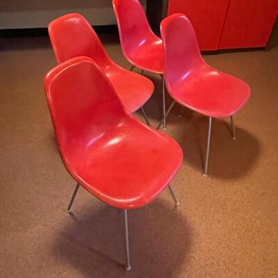 4 red Herman Miller molded plastic chairs