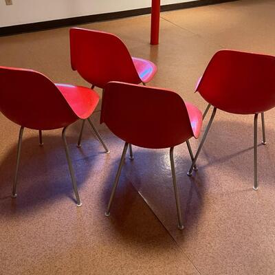 4 red Herman Miller molded plastic chairs