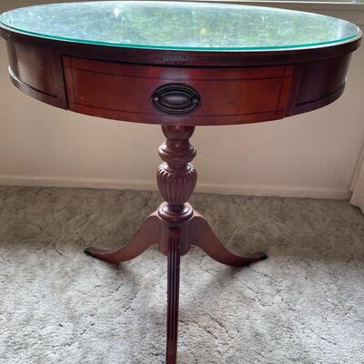 Round pedestal accent table with drawer
