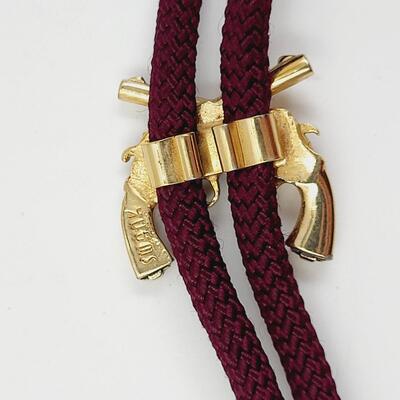 SWANK 2 GUN GOLD TONED BOLO TIE