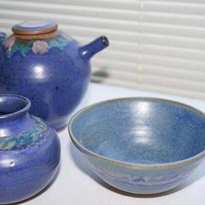 THREE PIECES OF BLUE GLAZE POTTERY W/FLORAL DECORATION.