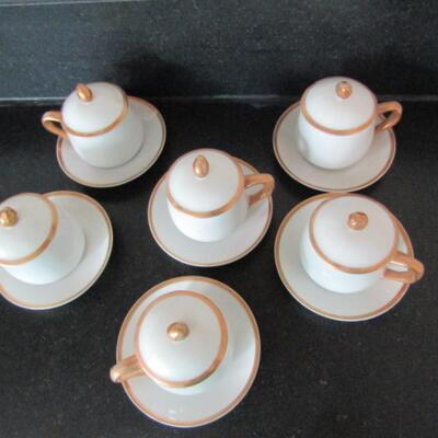 Six Porcelain Covered Pots de Creme with Saucers