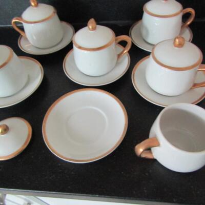 Six Porcelain Covered Pots de Creme with Saucers