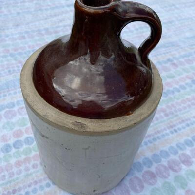 Vintage moonshine jug with brown top