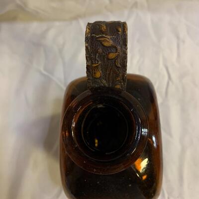 Leather sheathed brown bottle