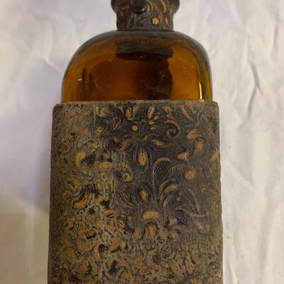 Leather sheathed brown bottle