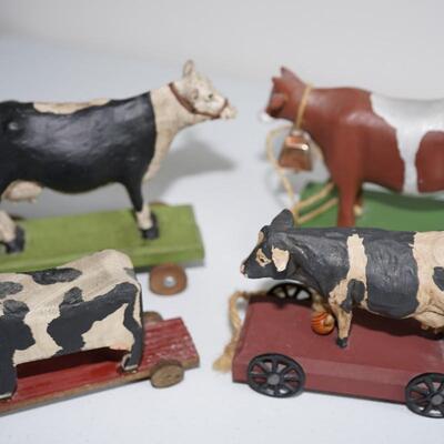 FOLK ART OF FOUR BOVINE BULL AND COW PULL TOYS ON WOOD PLATFORMS. ATTRUTED TO LEO SMITH