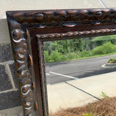 Large wooden framed beveled mirror