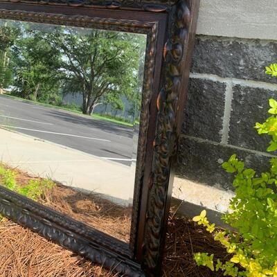 Large wooden framed beveled mirror