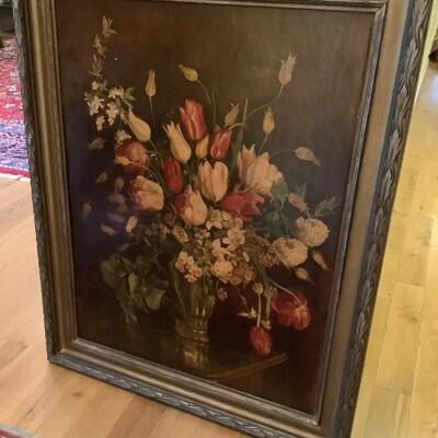 Artwork framed with darker back ground, arrangement of flowers 
Wire hanger, rubber buttons to protect the wall and stabilize the...