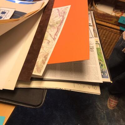 Artist Travel Bag Full of Paper targets, maps, and other wildlife items